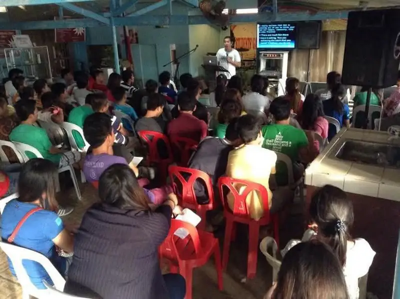 A full canteen of students listening to a speaker